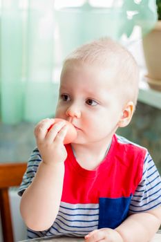 Portrait of a cute child with Easter eggs. Easter lunch. The feast of Holy Easter. Painted Easter eggs.