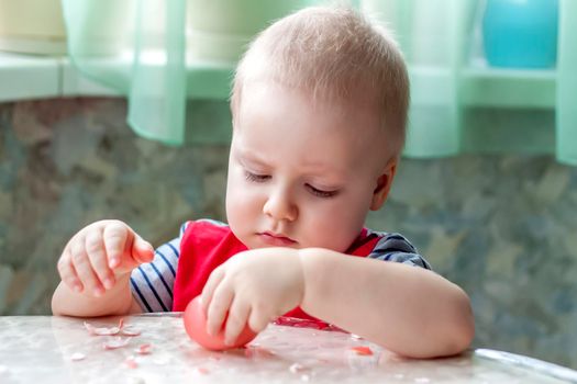 Portrait of a cute child with Easter eggs. Easter lunch. The feast of Holy Easter. Painted Easter eggs.