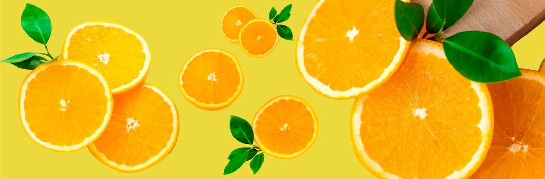Sliced orange on a bright orange background. Oranges in the panoramic image. Panorama, a banner with space for text or insertion. Pieces of citrus fruit. Template for creative and graphic works.