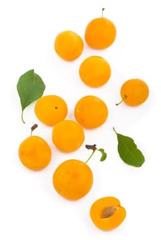 Yellow plum with leaves isolated on white background.