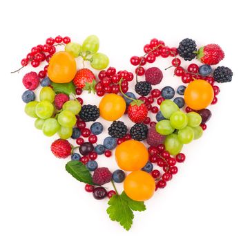 Heart shape assorted berry fruits on white background. Black-blue and red food. Mixed berries with copy space for text. Various fresh summer berries. Berries in heart shape isolateed on a white.