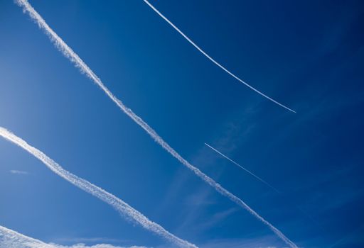 blue sky with many clouds lines made of aircraft.