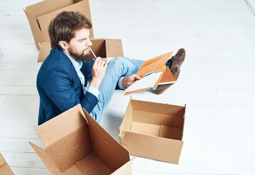 Man at home boxes with things moving work lifestyle. High quality photo