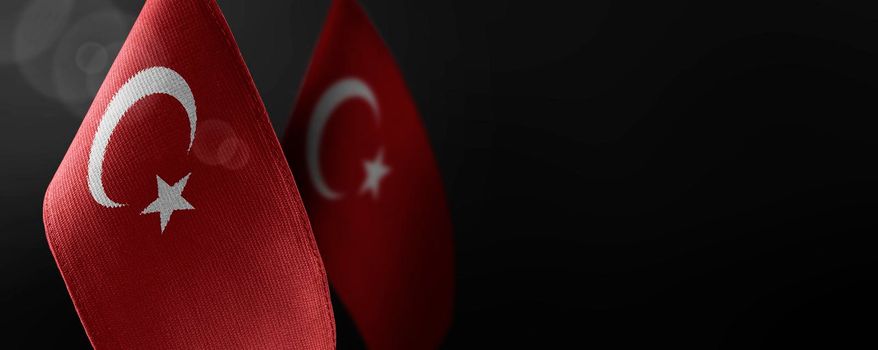 Small national flags of the Turkey on a dark background.