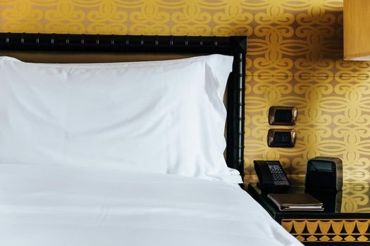 Image of Luxurious bedroom detail, furniture, lamp and accessories.