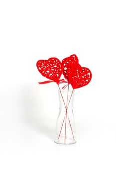 Transparent glass vase with hearts on a white background. The concept of a gift to a woman for valentine's day, a symbol of love,