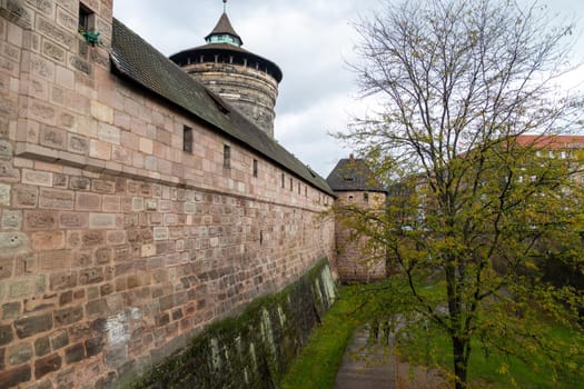 Old wall and tower at Handwerkerhof in city Nuremberg, Bavaria, Germany  in autunm