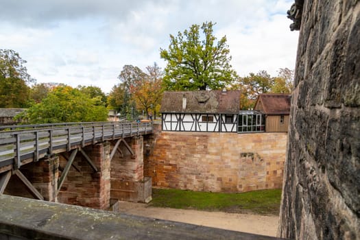 Historic wall and bridge of the Nuremberg castle, Bavaria, Germany  in autunm with multicolored trees