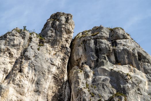 High rocks in the village Essing in Bavaria, Germany at the Altmuehl river on a sunny day in autumn with blue sky and white clouds