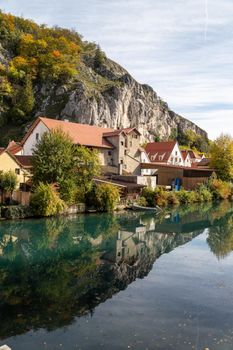 Idyllic view at the village Markt Essing in Bavaria, Germany with the Altmuehl river and high rocks on a sunny day in autumn