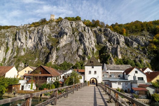 High rocks in the village Essing in Bavaria, Germany at the Altmuehl river on a sunny day in autumn with blue sky and white clouds