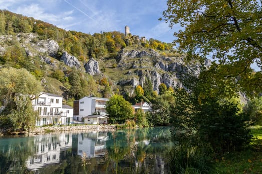 Idyllic view at the village Markt Essing in Bavaria, Germany with the Altmuehl river and high rocks on a sunny day in autumn