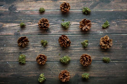 Pinecones and Cannabis Nugs on a Wooden Background in a Diagonal Pattern