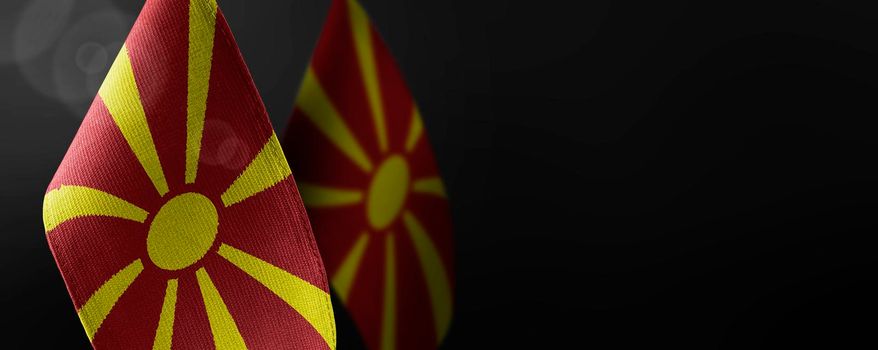 Small national flags of the Macedonia on a dark background.