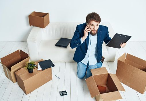 man talking on the phone unpacking boxes office work new place businessman. High quality photo