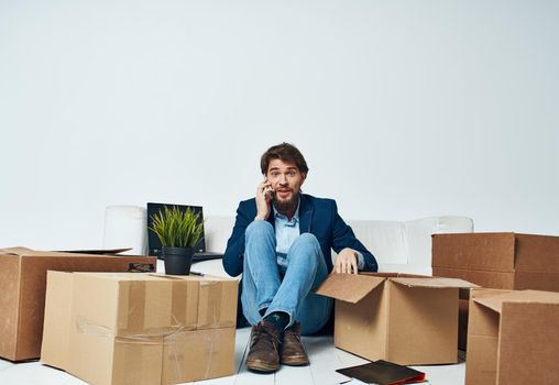 Man in a suit boxes with things moving office professional unpacking. High quality photo