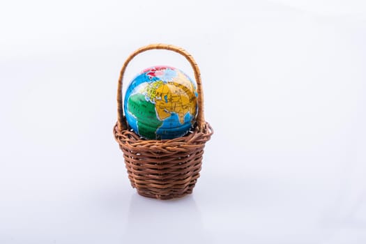 Little model globe in a basket in view