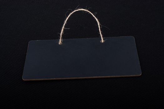 Rectangular shaped black notice board on black background