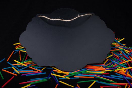 Black speech bubble shaped notice board  on colorful sticks on black