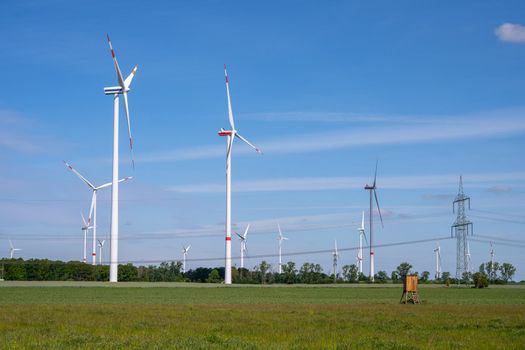 Modern windmills and a power line in Germany