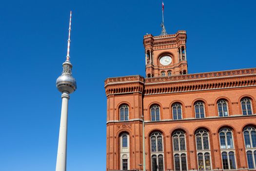 The famous Television Tower and the town hall in Berlin in front of a clear blue sky