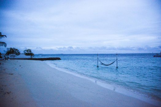 atoll of the tropics and maldives that are reflected in a sea of emerald with a cobalt blue sky