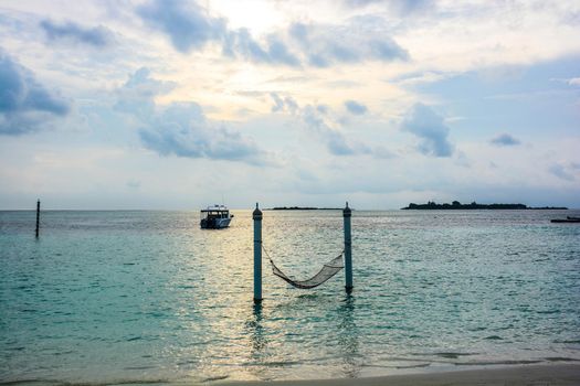 atoll of the tropics and maldives that are reflected in a sea of emerald with a cobalt blue sky