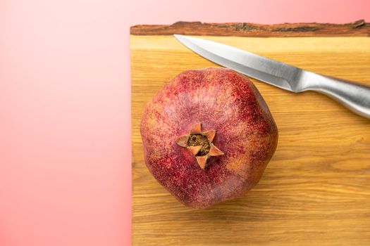 ripe pomegranate on a pink background. love. Fruit. High quality photo