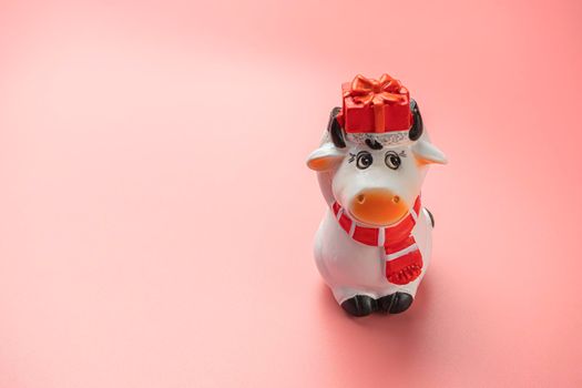 bull figurine on a pink background. symbol of 2021. High quality photo