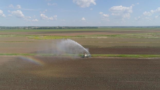 Aerial view of Crop Irrigation using the center pivot sprinkler system. An irrigation pivot watering agricultural land. Irrigation system watering farm land.