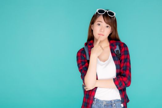 Beautiful portrait young asian woman wear sunglasses on head smile confident thinking and idea summer holiday isolated blue background, model girl fashion in vacation, travel concept.