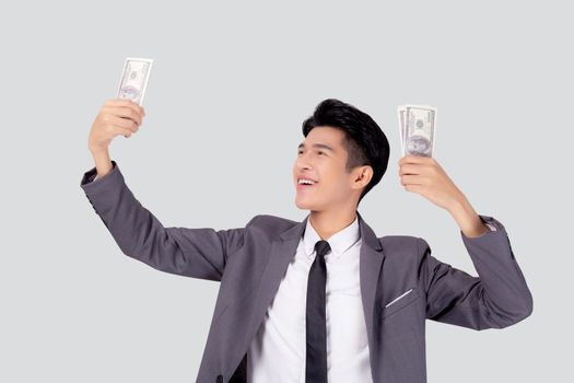 Young asian business man holding money dollar isolated on white background, businessman in suit holding banknote and success and excited with finance, savings and investment, income and spending.