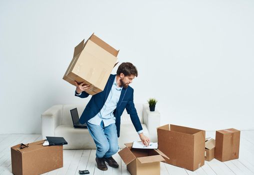 a man with a box of things unpacking a new place office lifestyle official. High quality photo