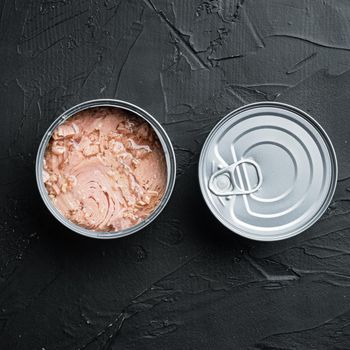 Canned Albacore Wild Tuna set, in tin can, on black background, top view flat lay, with copyspace and space for text, square format