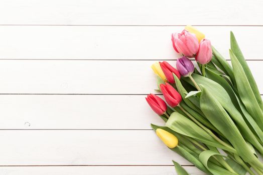 Spring concept. Tulip bouquet on black wooden background with copy space