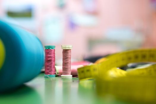 Close up of measuring tape and sewing thread a textile workshop