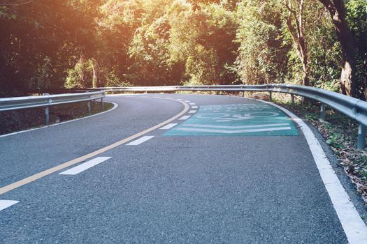 Road with bicycle lane in the country with nature surrounding background.