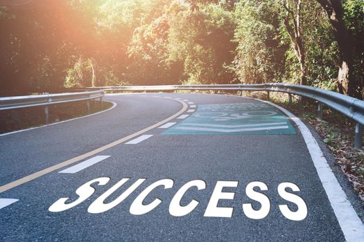 Success word on road in wood represents the beginning of a journey to the destination in business planning, strategy and challenge or career path, opportunity concept.