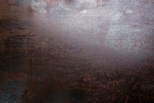 rusted black steel sheet surface covered with machine oil in flat lay perspective
