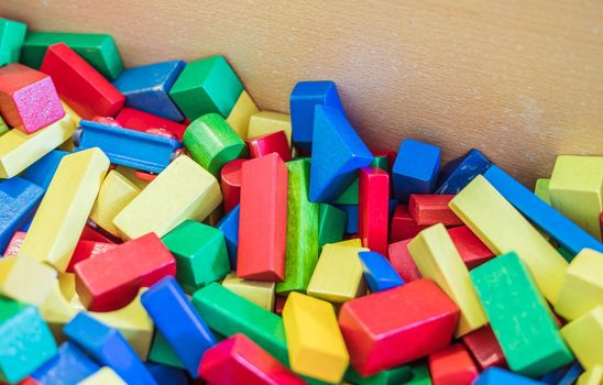 Colorful wooden toy blocks in a box