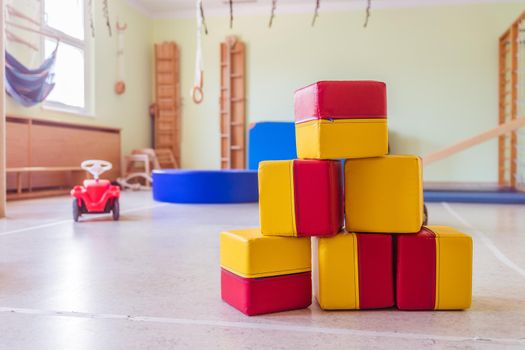 Close up of toy foam cubes in a gym hall of a Kindergarten