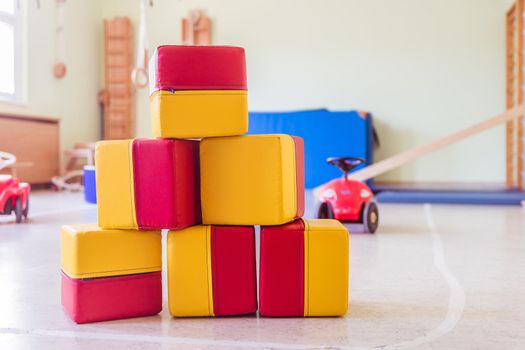 Close up of toy foam cubes in a gym hall of a Kindergarten
