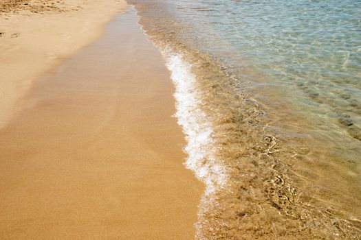 Mesmerizing shot of soft waves on a sandy beach