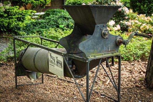 Selective focus shot of an agricultural machine designed for hulling clover, millet, alfalfa seeds