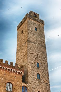 View of Torre Grossa, the tallest medieval tower and one of the main attractions in the central square of San Gimignano, Tuscany, Italy