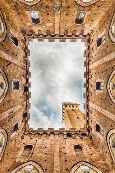 Scenic view from the bottom at the patio of Palazzo Pubblico, major landmark in Siena, Italy
