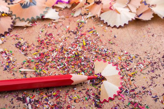 Red Color Pencil over some  pencil shavings