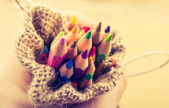 Color Pencils in a linen sack on canvas