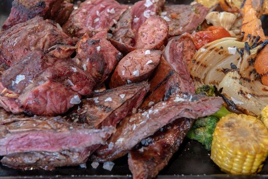 Complete grill of Argentine Asado of meat with vegetables and served in Brasero.