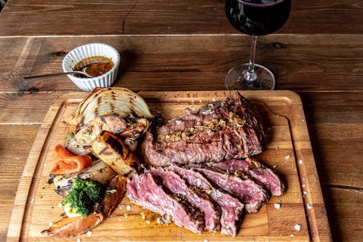 Argentine cut of meat called Vacio with chorizos and chimichurri.